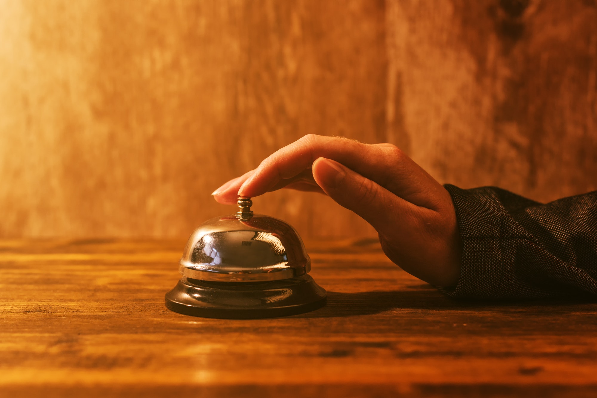 businesswoman ringing hotel reception bell