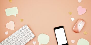 Social media concept flatlay with keyboard, phone, mouse