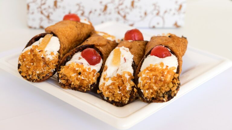 Four Sicilian cannoli with ricotta and pieces of candied pumpkin