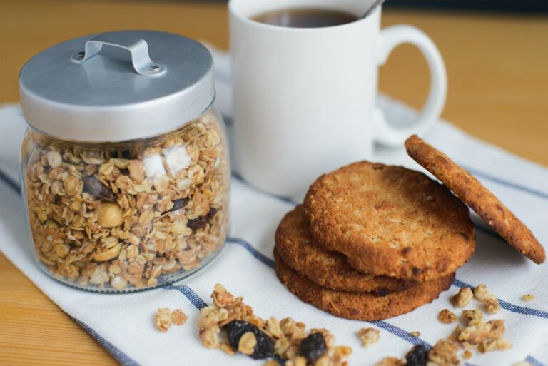 wholemeal oatmeal cookies stack with granola and coffee on napkin