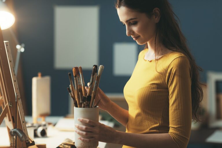 Woman choosing the brushes for her artwork