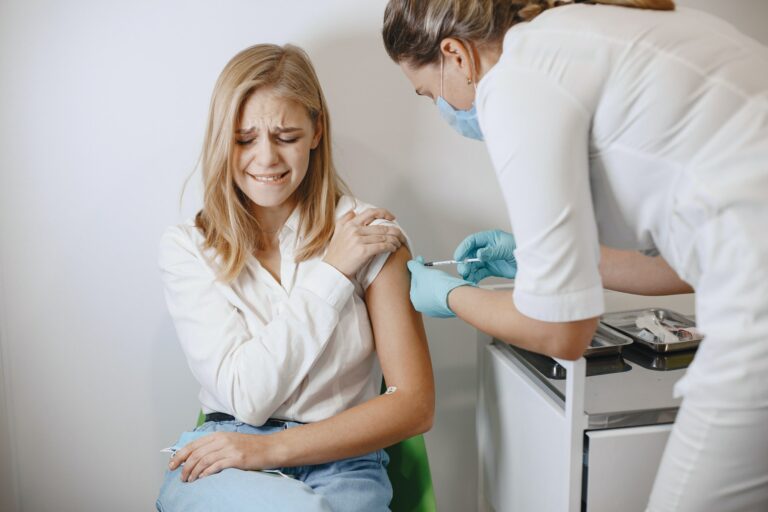 Woman doctor gives a vaccine to patients