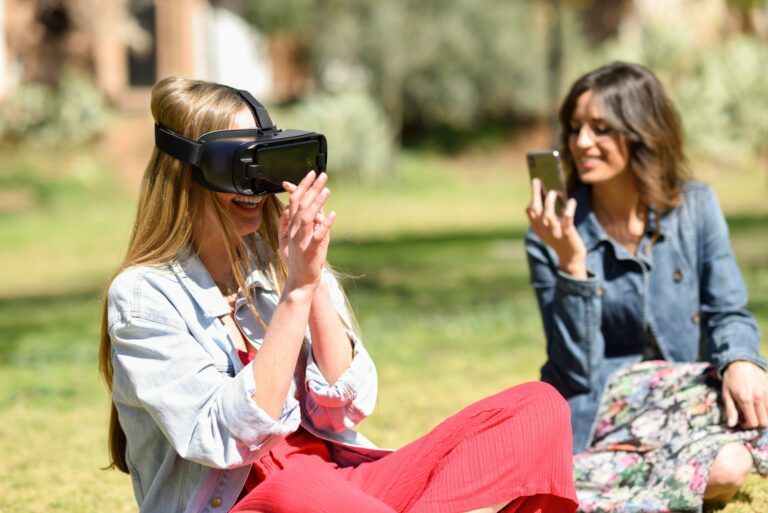 Woman looking in VR glasses and gesturing with his hands outdoor