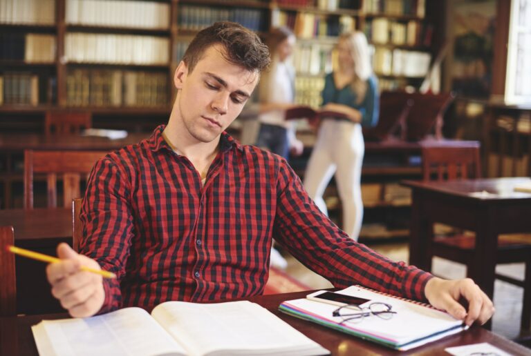 Young student studying in library