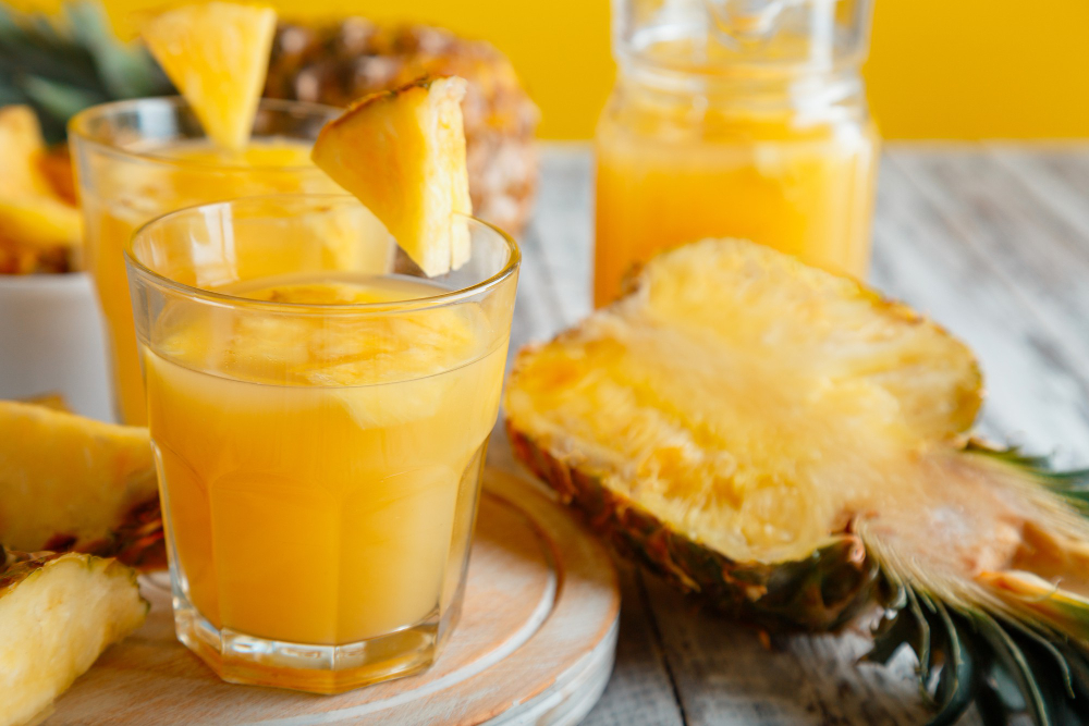 tasty pineapple juice glass with pineapple fruit slices fresh natural pineapple cocktail juice glass white wooden table high quality stock photo