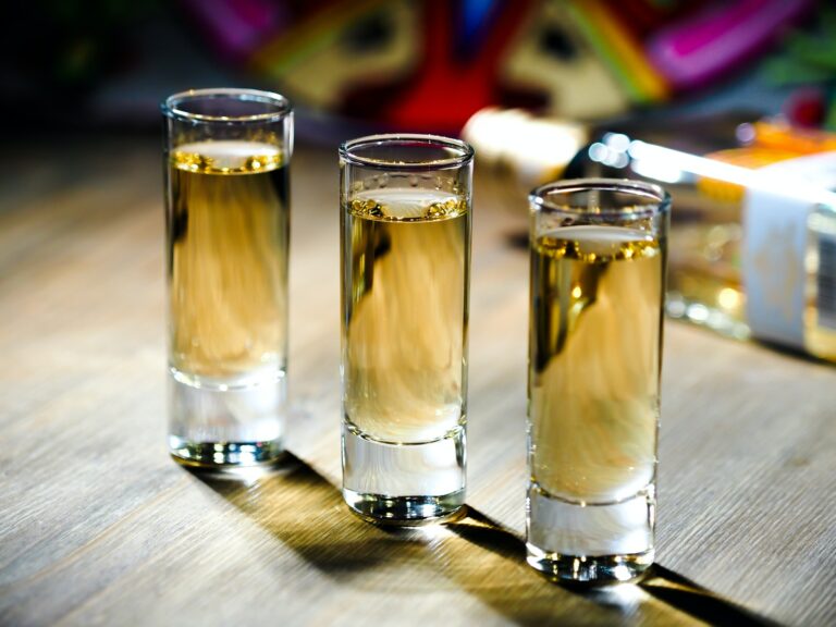 Three shots of tequila in tall shot glasses
