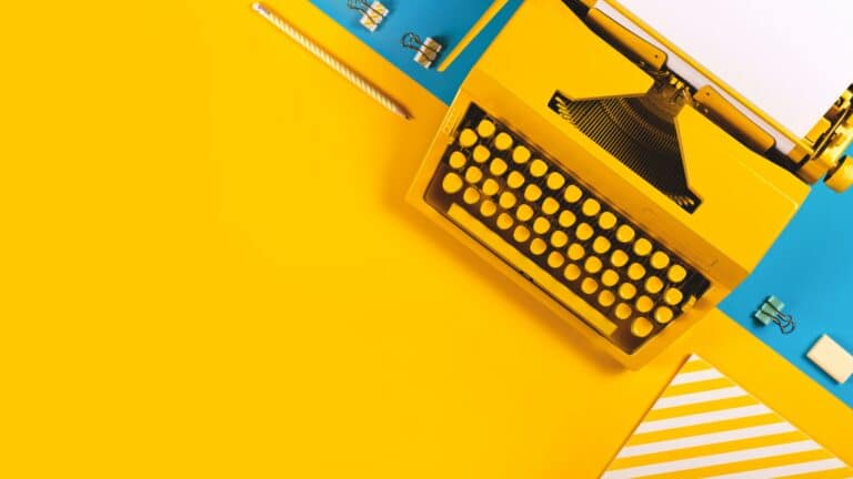 Yellow bright typewriter on a yellow and blue background