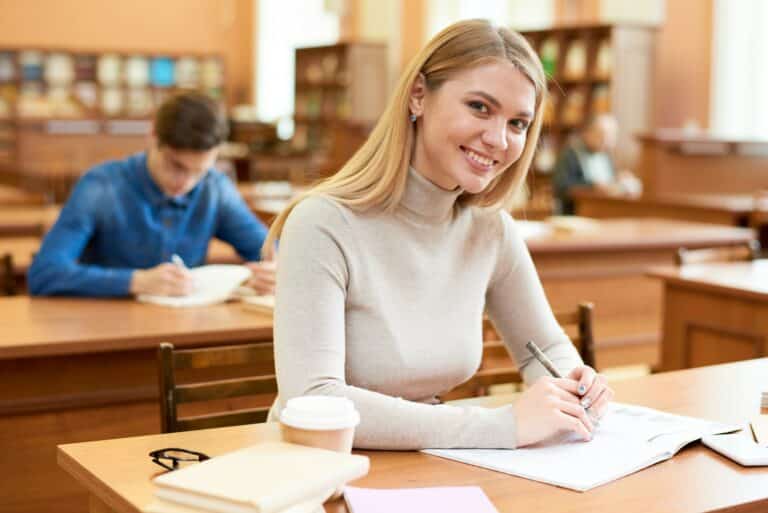 Happy student girl enjoying time in library
