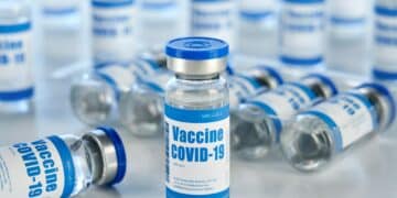 Covid 19 vaccine vial bottles, corona virus cure manufacturing production.