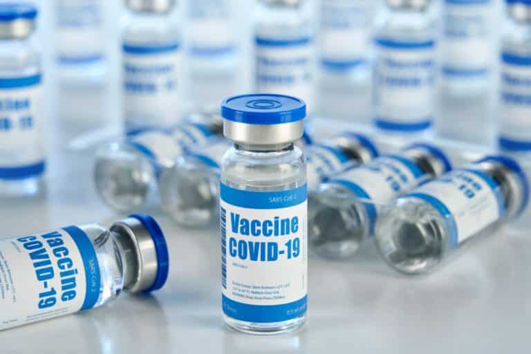 Covid 19 vaccine vial bottles, corona virus cure manufacturing production.