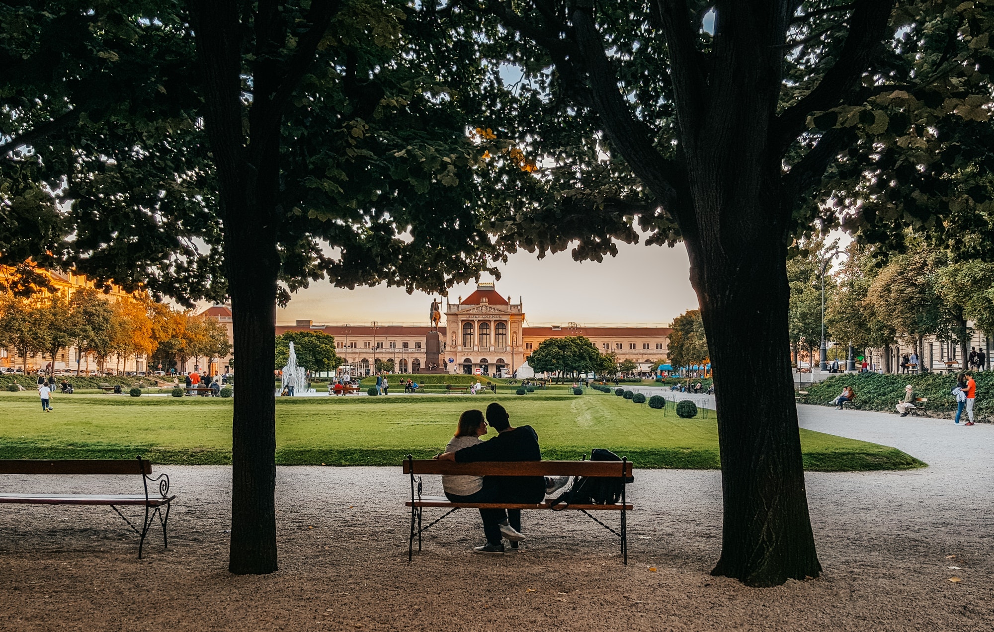 Rear view of a couple sitting on park bench in city of Zagreb in Croatia.