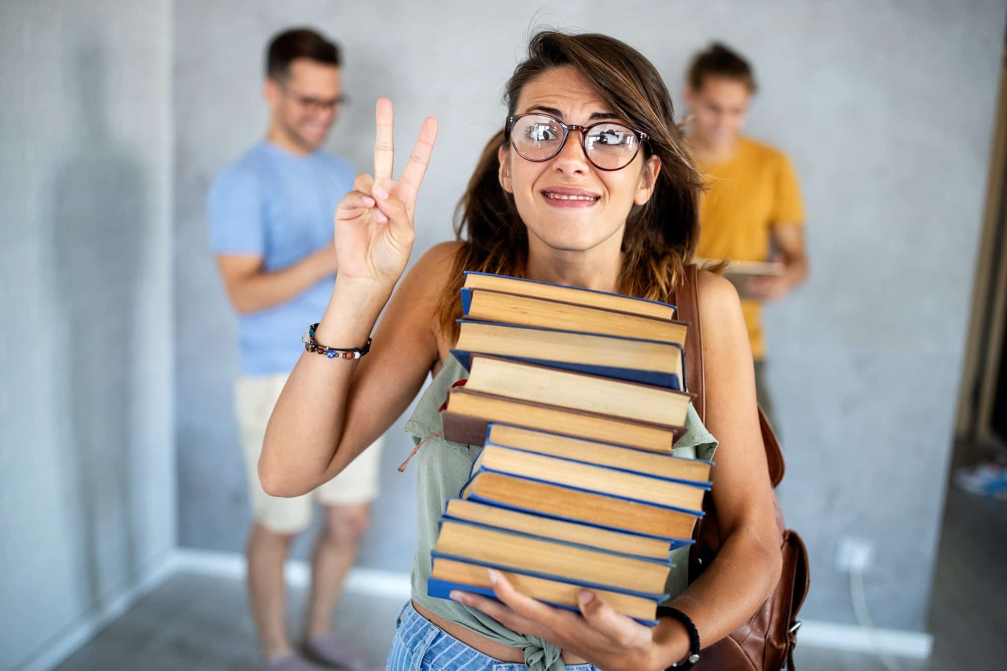 Stylish nerd girl with many books. Education, study, people, university concept