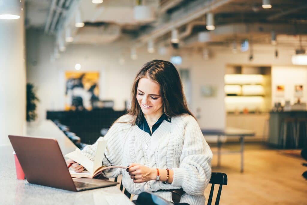 businesswoman working on laptop in modern coworking