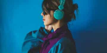 young woman in 90s style jacket and with headphones