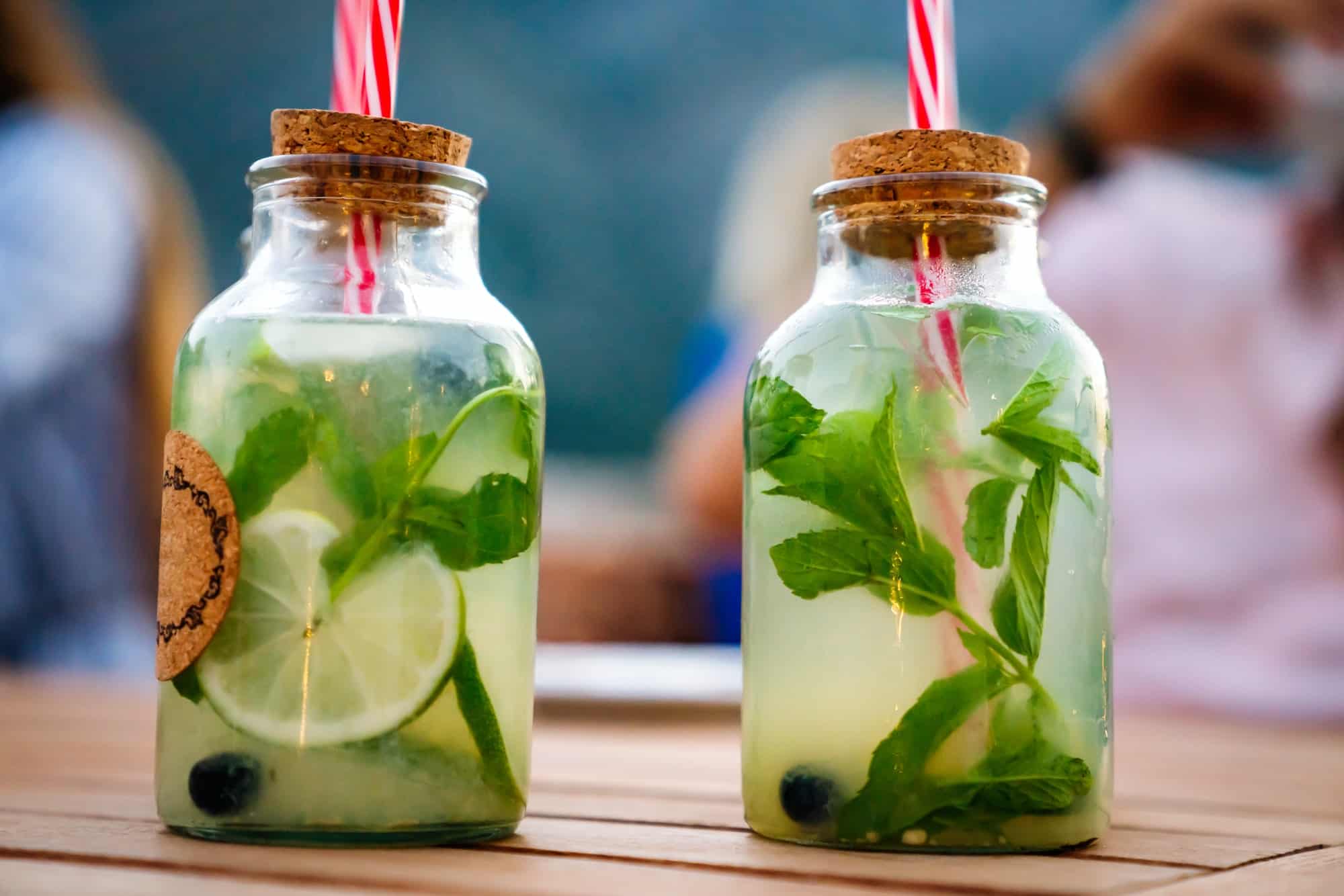 cold refreshing limonade mojito or gin tonic in glass with fresh mint and ice cubes