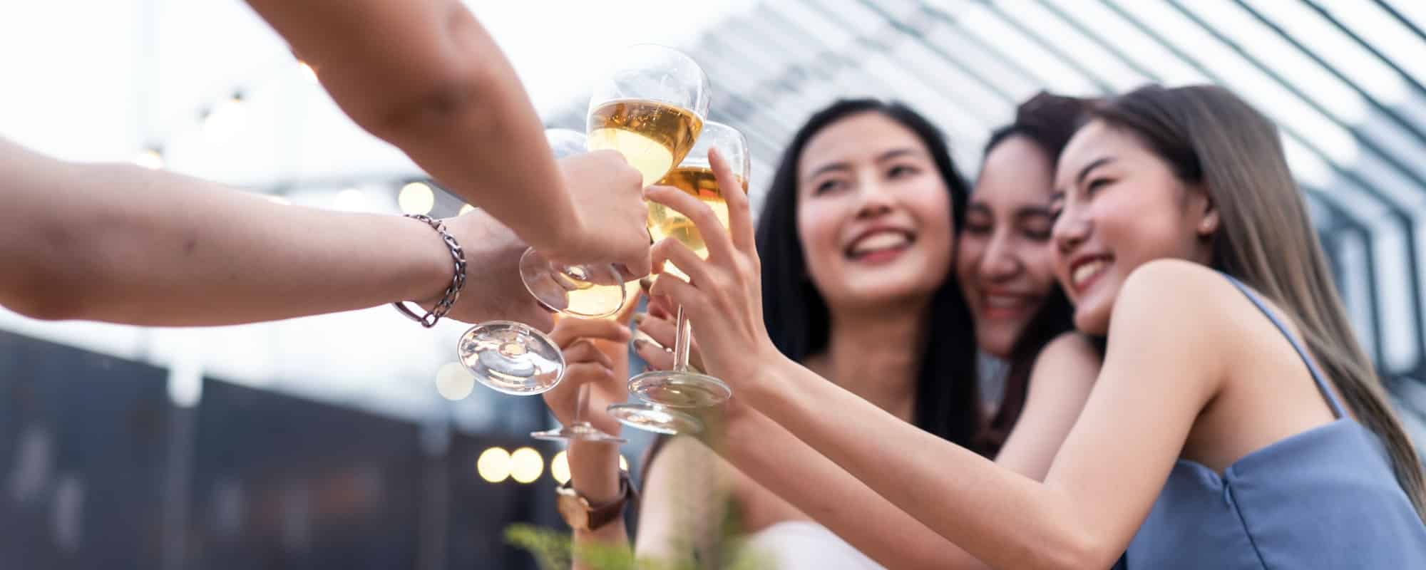 group of asian woman friends drinking beer alcohol having party at rooftop restaurant