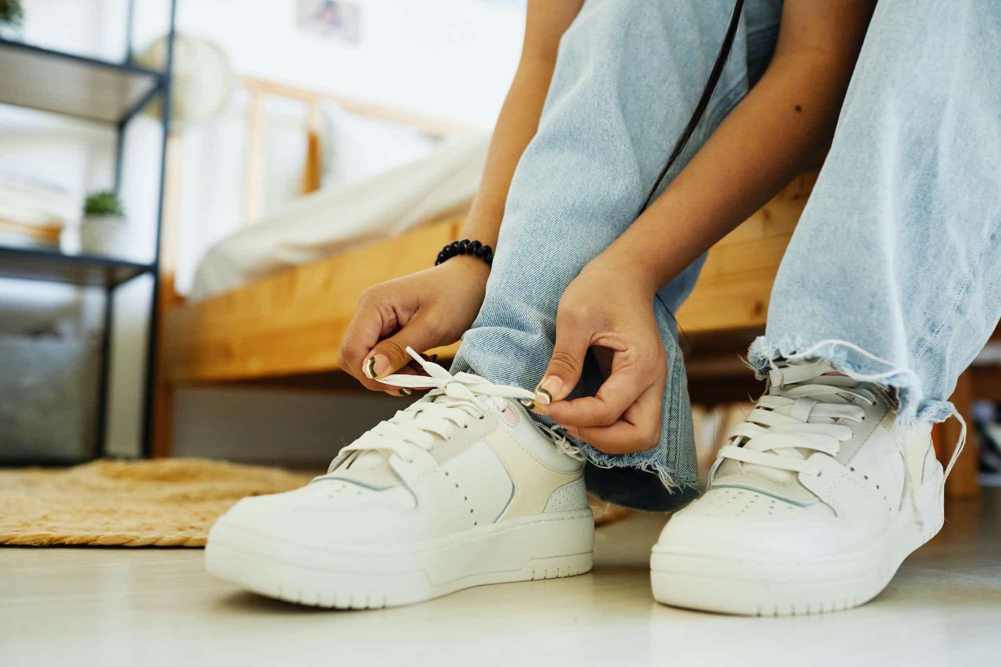 girl putting on sneakers close up