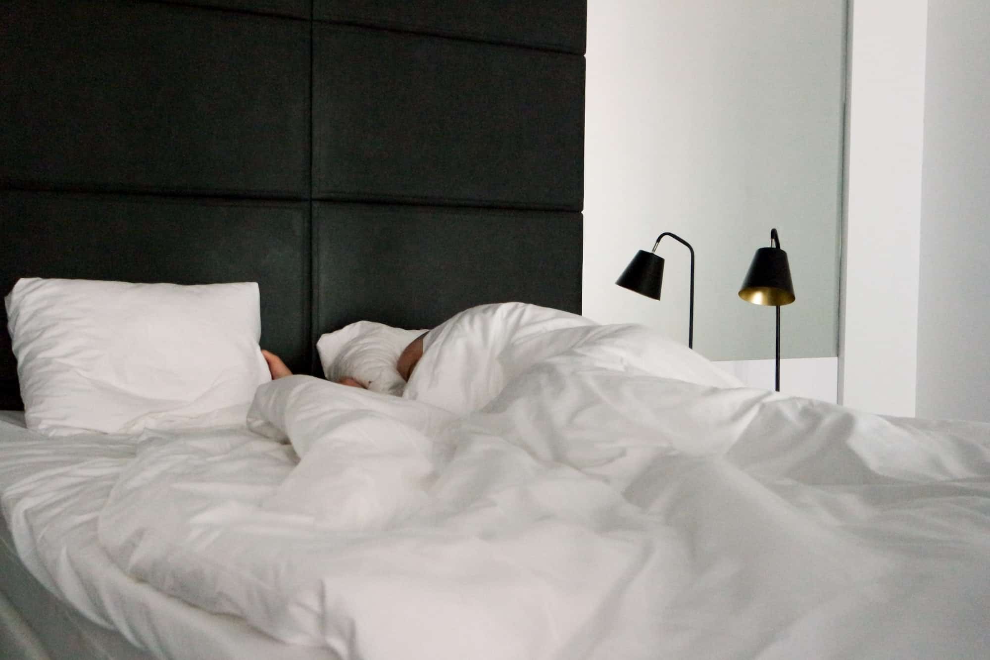 man sleeping in the hotel room lazy morning cozy bed bed vibes nominated