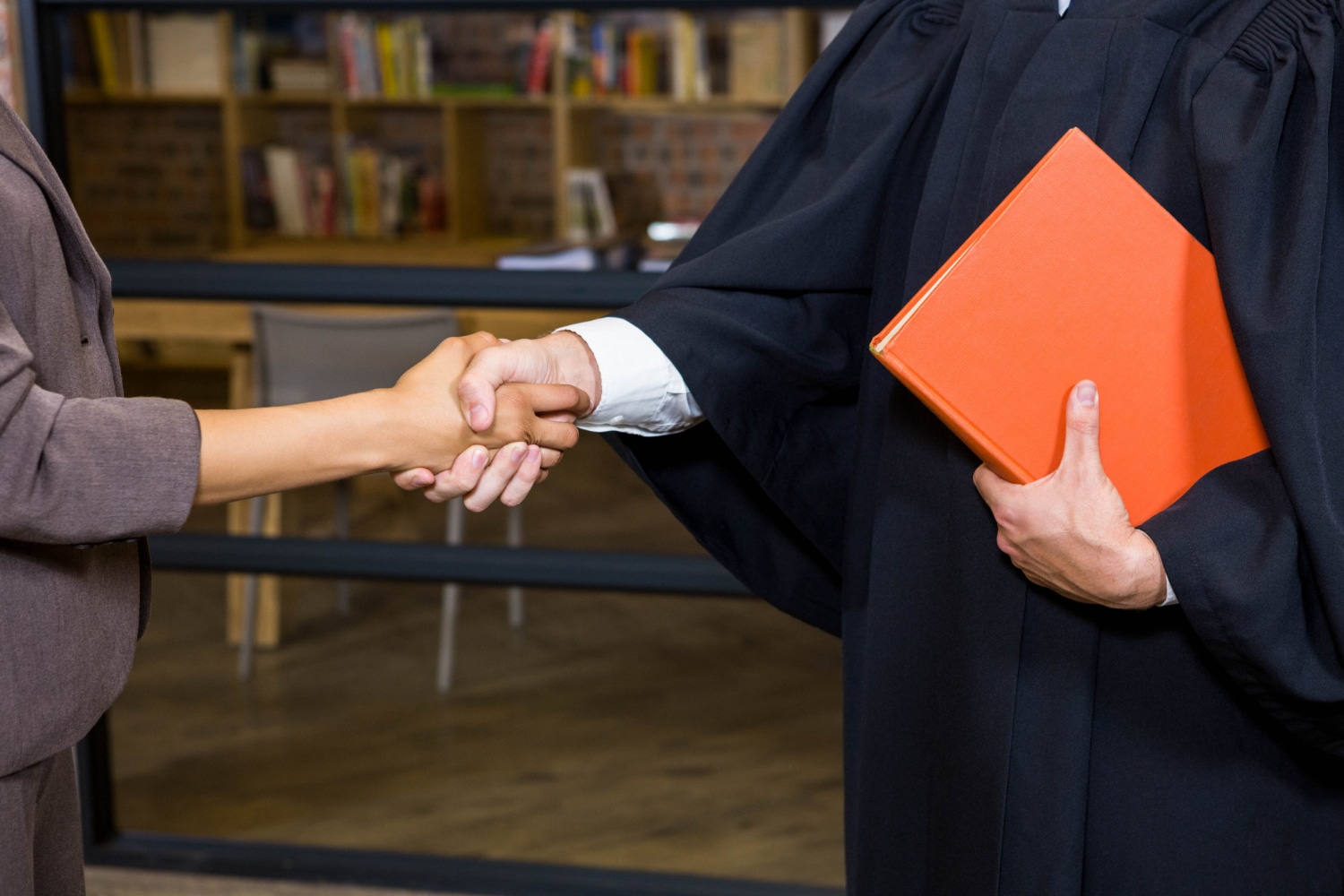 businesswoman shaking hands with lawyer office
