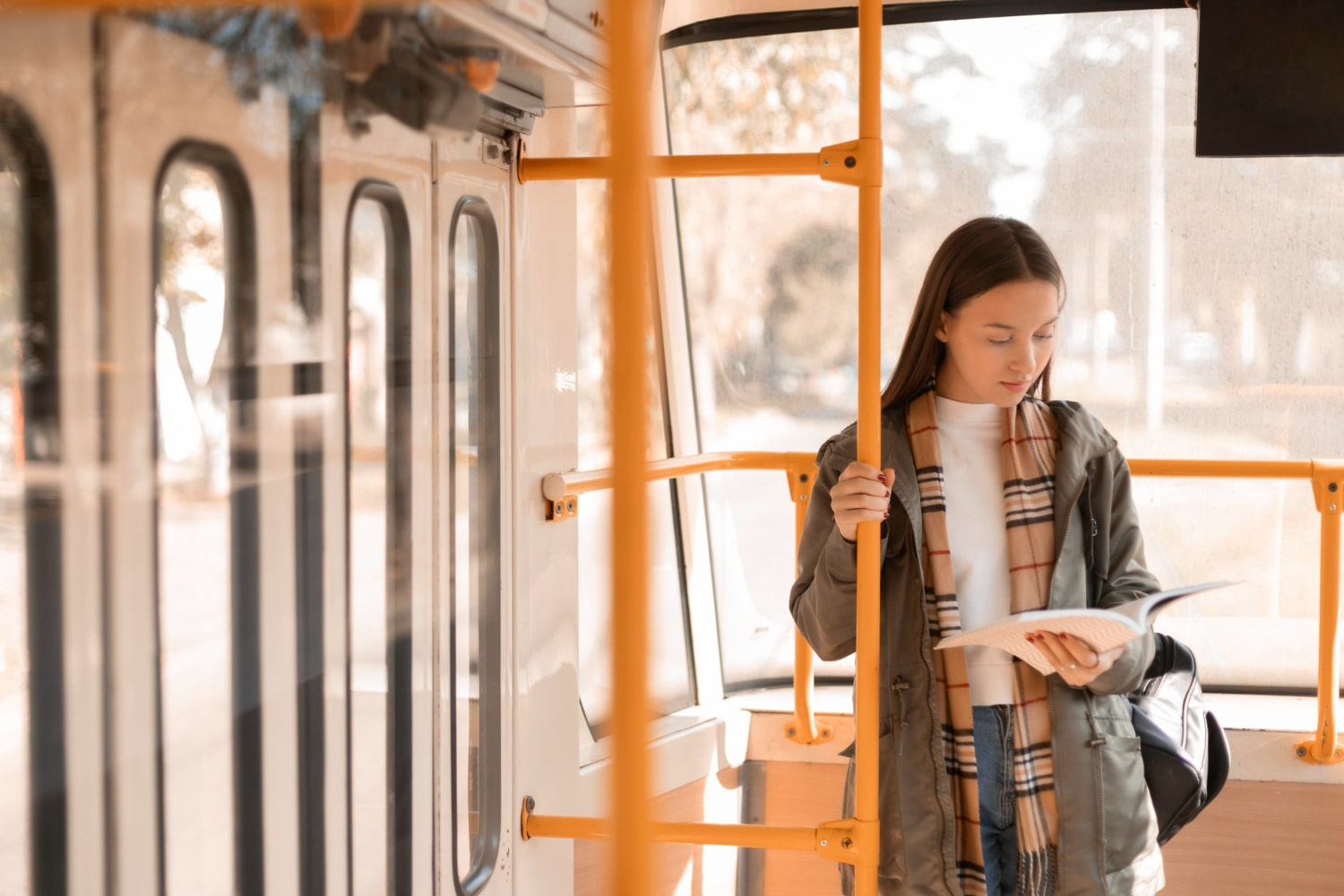 female passenger reading travelling by tram