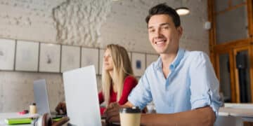 modern young man woman working laptop open space co working office room