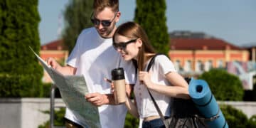 tourist couple outdoors with map