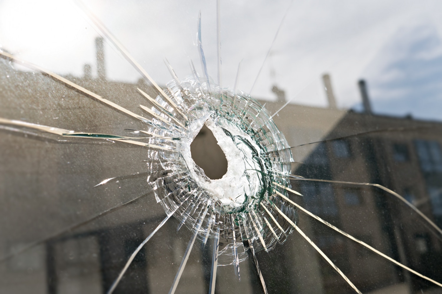 vandalism violence concept broken glass with hole