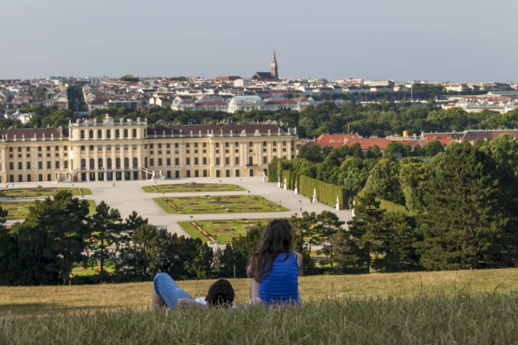 Couple looking at the castle view from the hill in Vienna, Austria