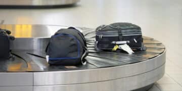 baggage conveyor belt airport baggage claim area airport abstract luggage line with many suitcases