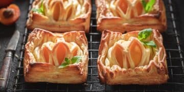 Sweet puff pastry with peaches and mint. French juicy dessert.