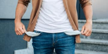 close up hands pulling out jeans pockets