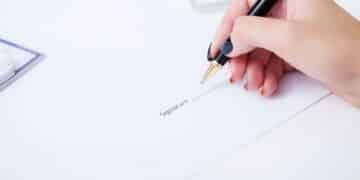 business woman signing a contract above signature line