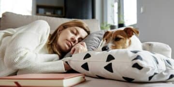 woman sleep with dog on sofa